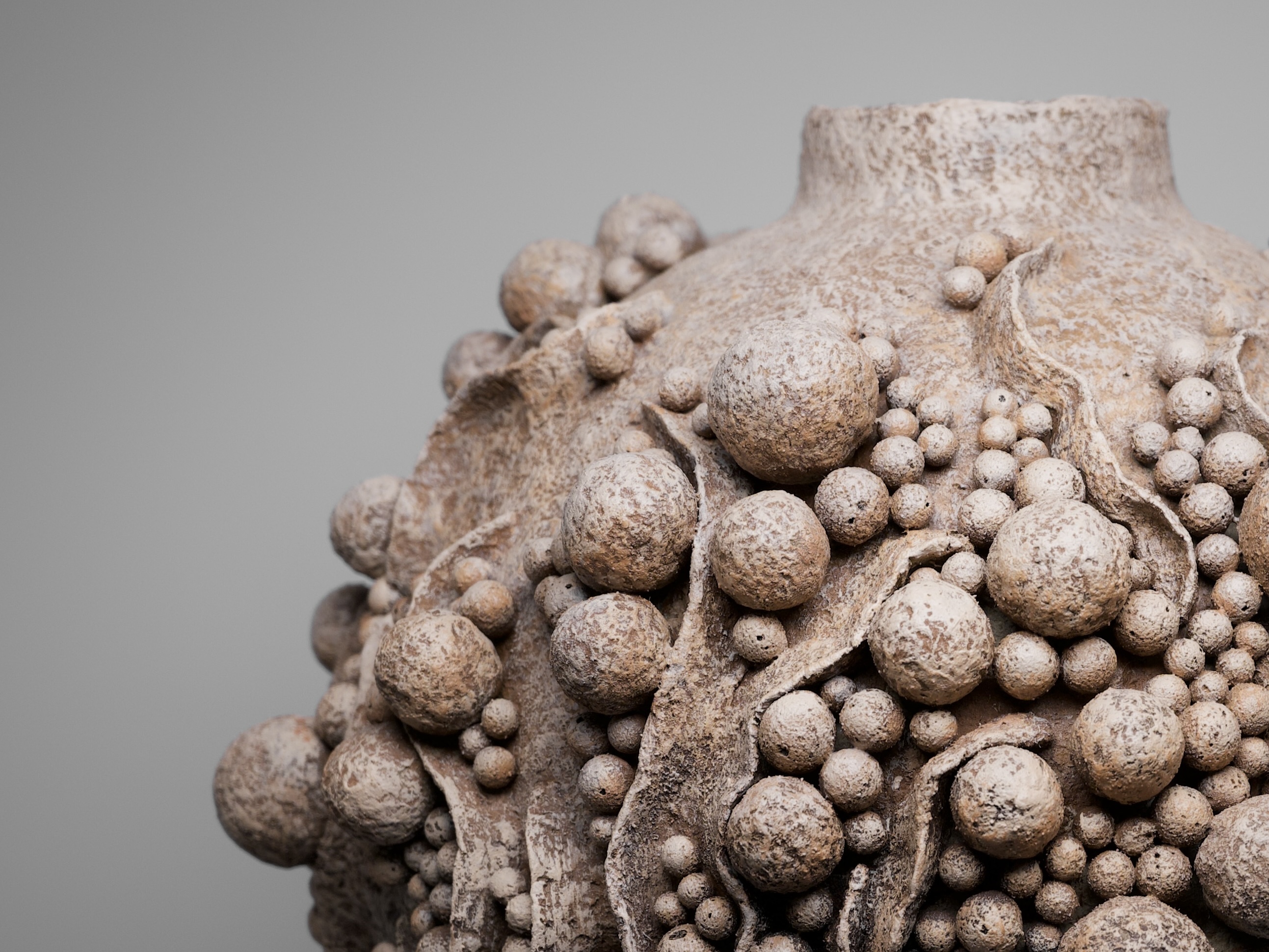 Floramundis sculptural vessel, textured paper clay form with organic spherical surface