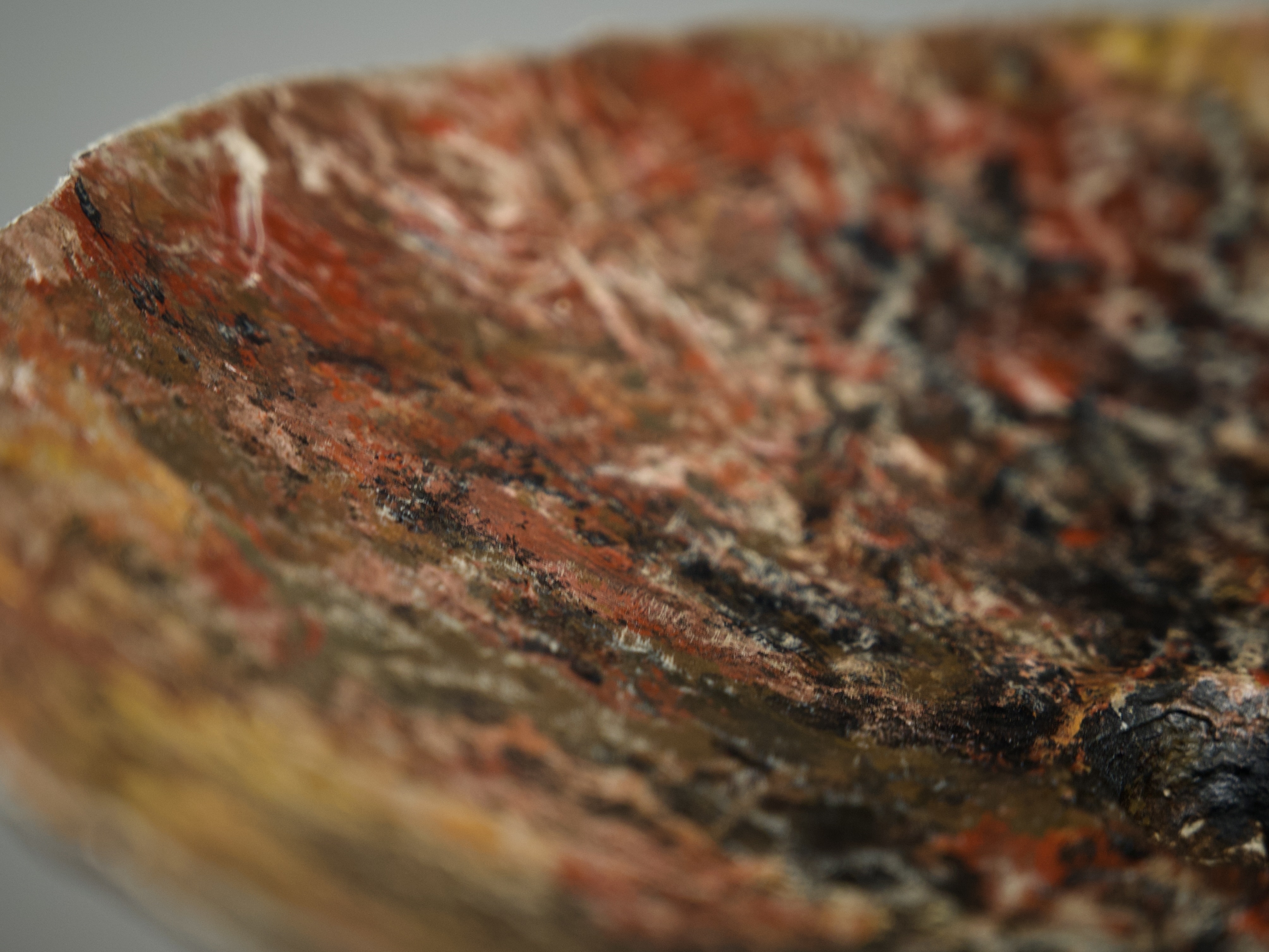 Close-up of sculptural vase surface in paper and natural clay with ash and mineral pigments